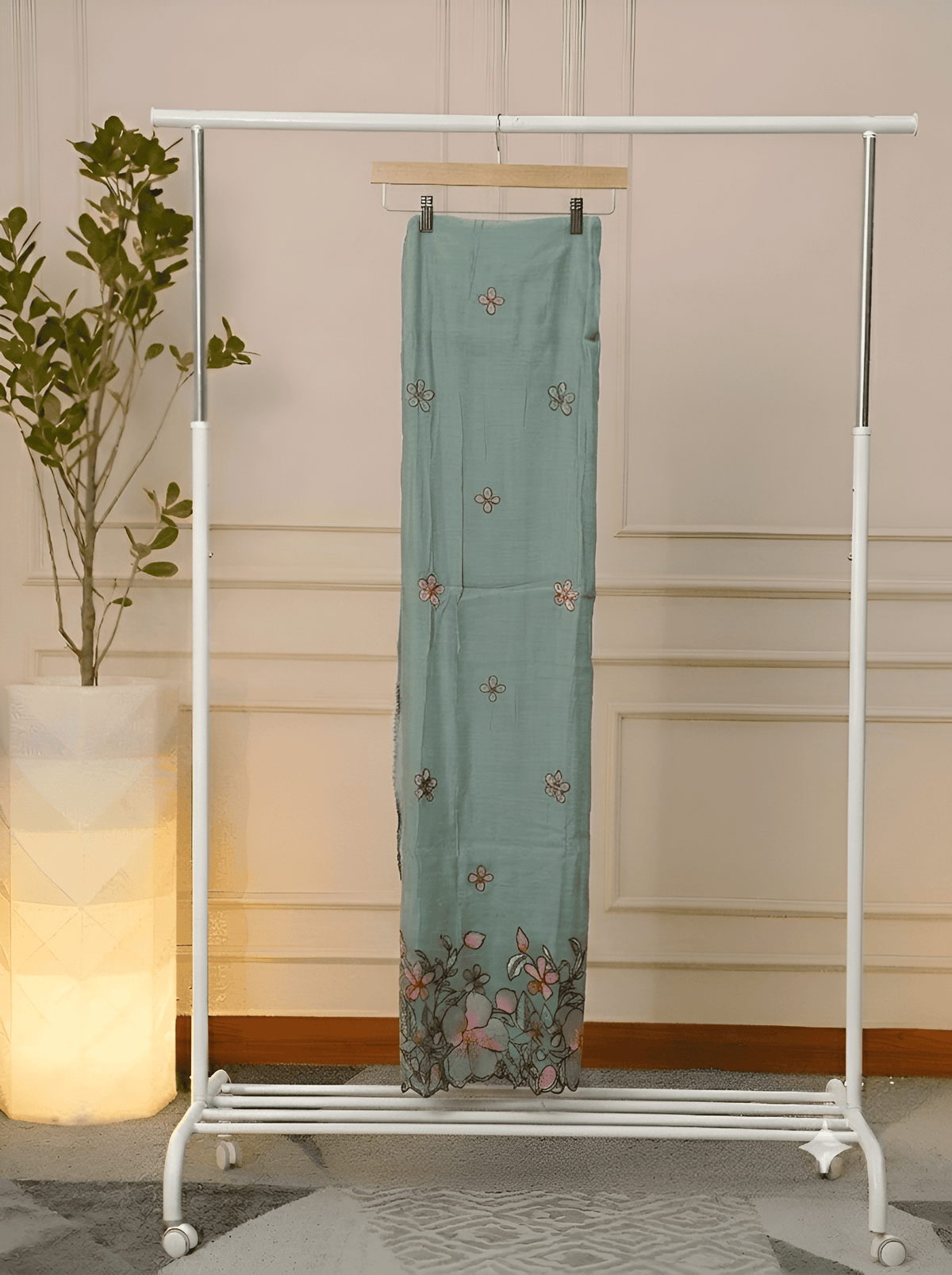 pink flower embroidery motif on sage green suit fabric